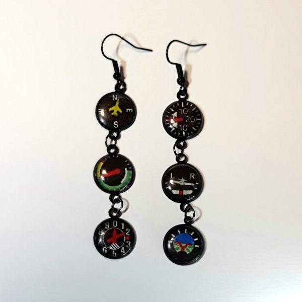 Female earrings showing flight instruments from a plane