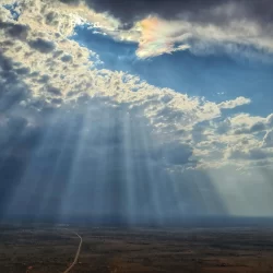 Hands of God with Cloud iridescence in Yulara Ayers Rock Uluru Northern Territory Australia. Air Charters